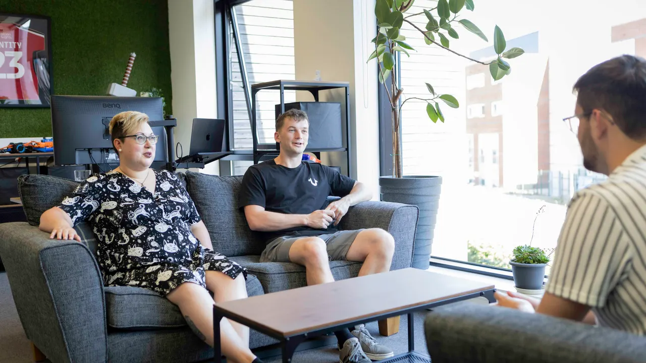A team having a meeting around a sofa